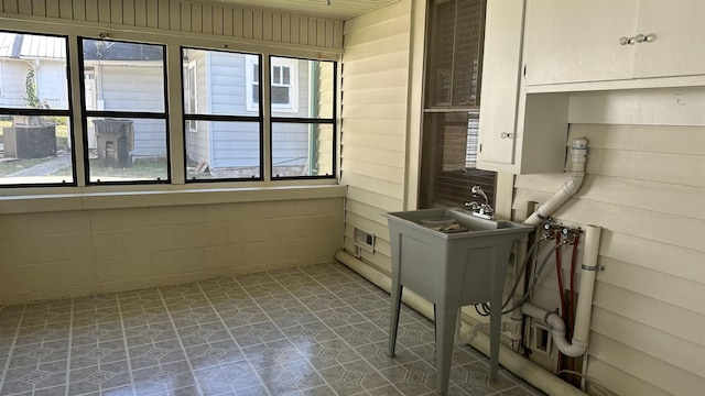 clothes washing area with washer hookup and wood walls