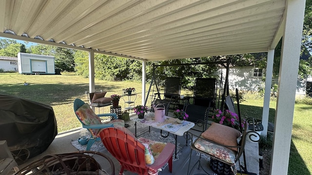 view of patio with a grill and a storage unit