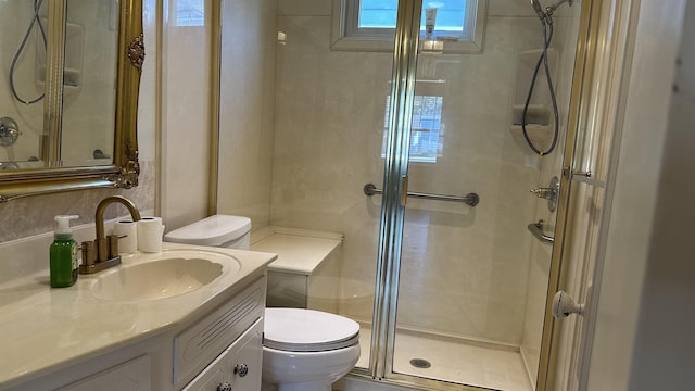 bathroom with vanity, an enclosed shower, and toilet