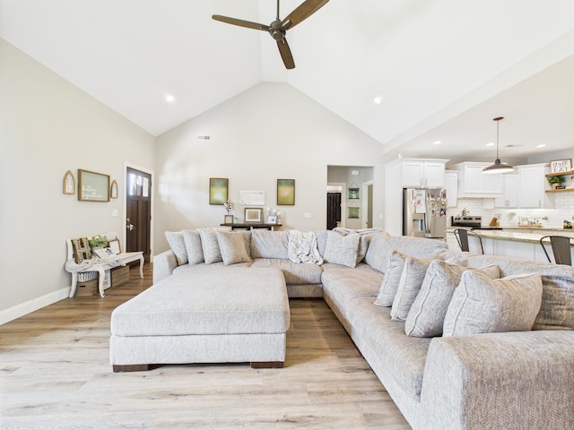  - living room with a ceiling fan, light wood finished floors, recessed lighting, and high vaulted ceiling