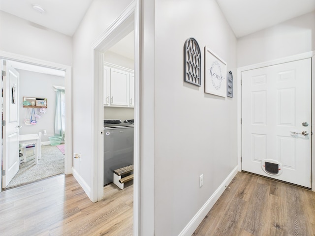 - foyer with washing machine and dryer and light wood-style floors