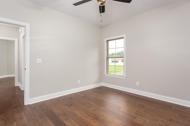 spare room featuring dark hardwood / wood-style floors and ceiling fan