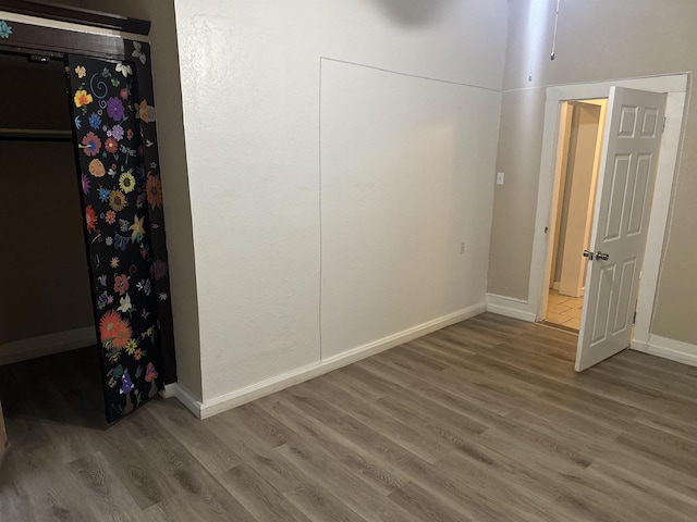 unfurnished bedroom featuring hardwood / wood-style flooring and ceiling fan