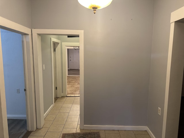 hall featuring light tile patterned flooring