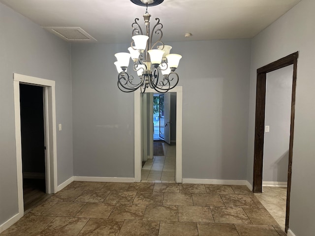 unfurnished dining area featuring an inviting chandelier