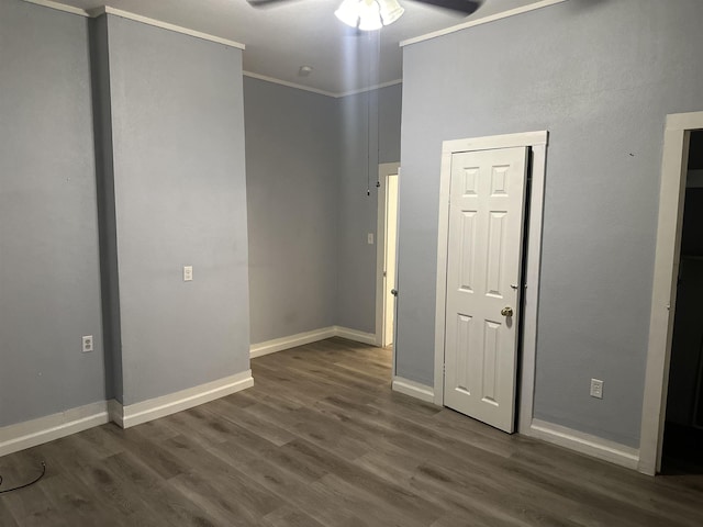 interior space featuring ceiling fan, dark wood-type flooring, and ornamental molding