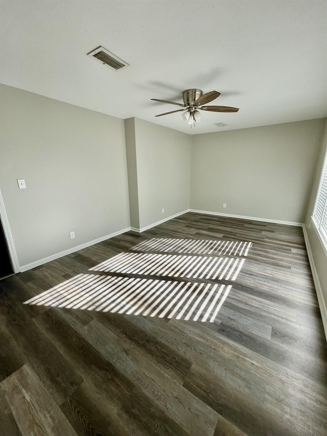 unfurnished room with ceiling fan and dark hardwood / wood-style floors