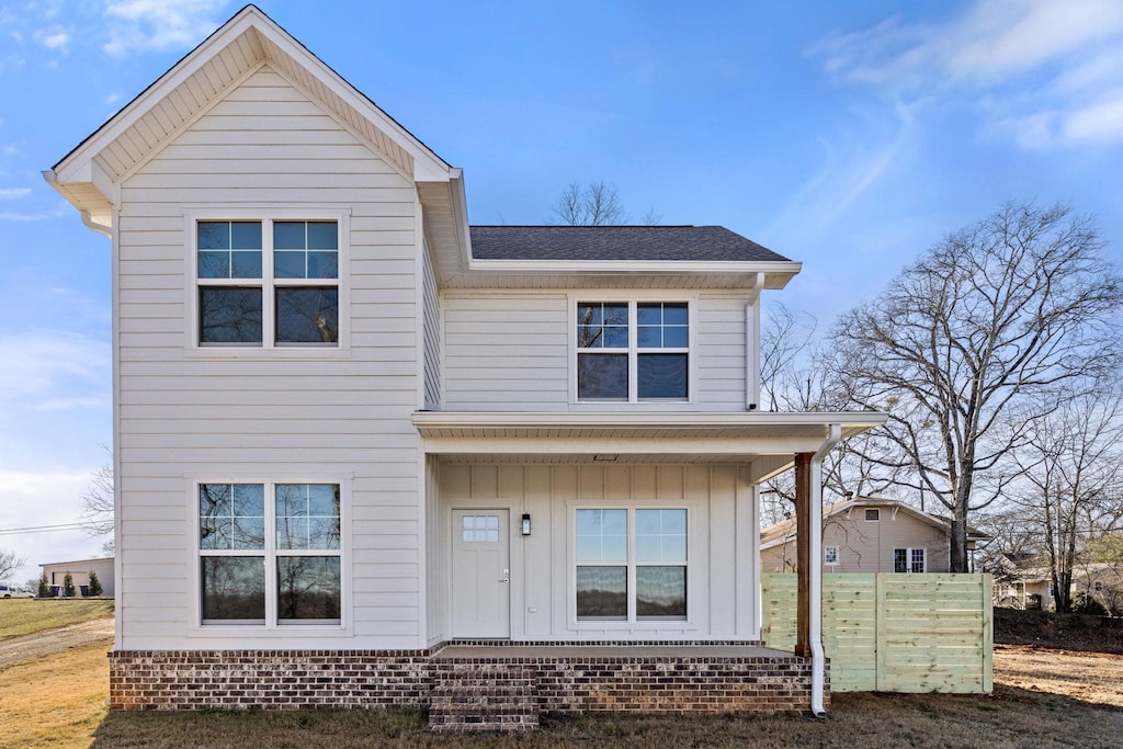 view of front of home with a porch, board and batten siding, and a shingled roof