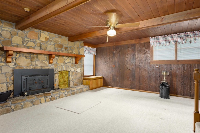 unfurnished living room with light carpet, plenty of natural light, and wood walls