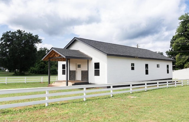  - view of side of property featuring roof with shingles