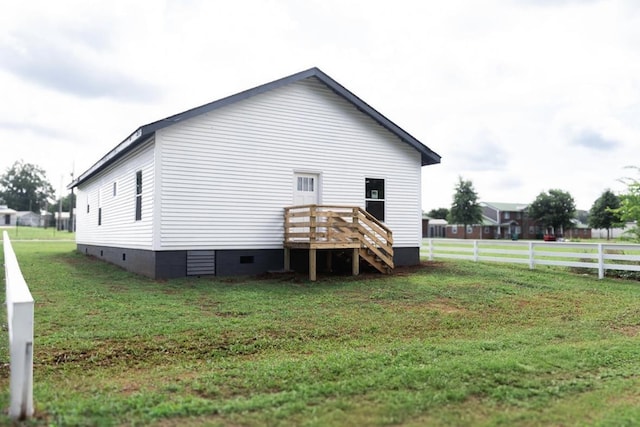  - view of side of home with crawl space and a wooden deck