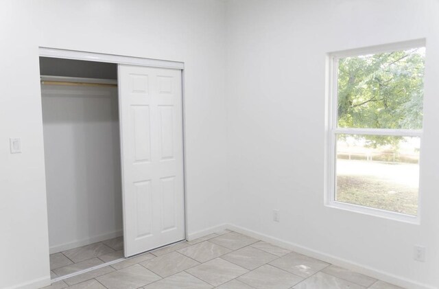  - unfurnished bedroom with a closet and baseboards