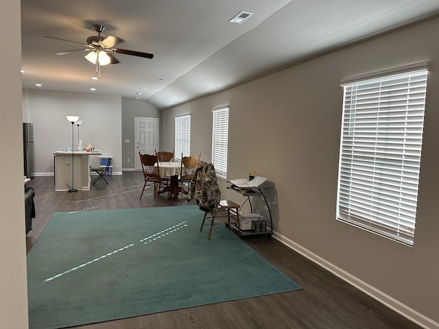 dining area with vaulted ceiling, ceiling fan, and dark wood-type flooring