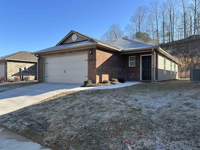 view of front of property with central AC unit and a garage