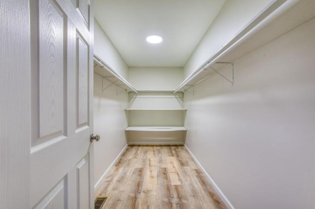 spacious closet with light hardwood / wood-style floors