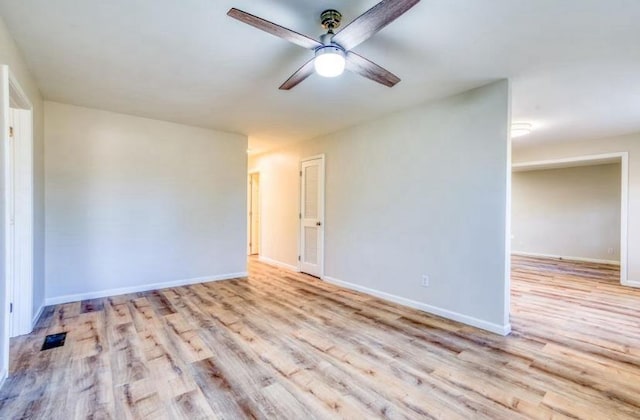 empty room with light hardwood / wood-style flooring and ceiling fan