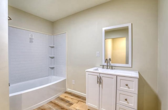 bathroom featuring wood-type flooring, vanity, and tub / shower combination