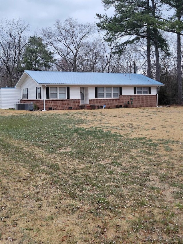 ranch-style house with central AC unit and a front lawn