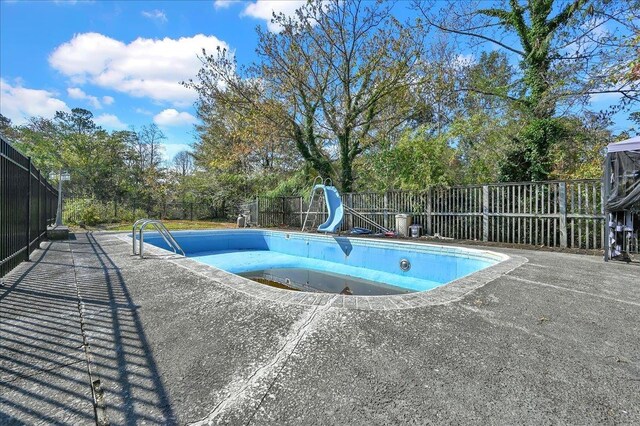 view of pool with a water slide