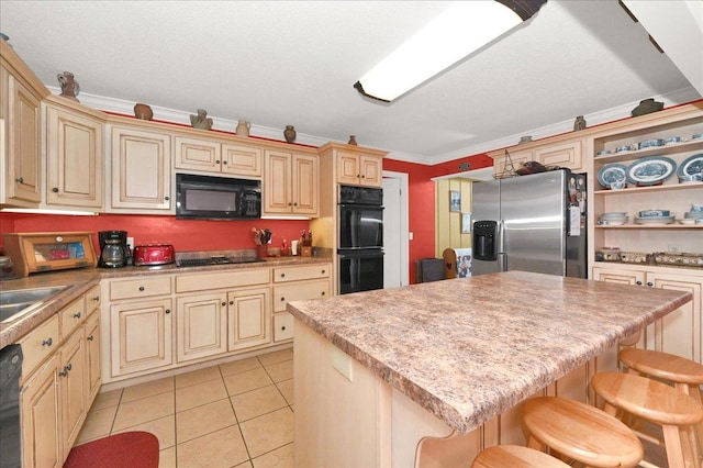 kitchen with crown molding, black appliances, light tile patterned floors, a kitchen island, and a breakfast bar area