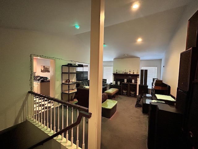 corridor featuring carpet floors and lofted ceiling