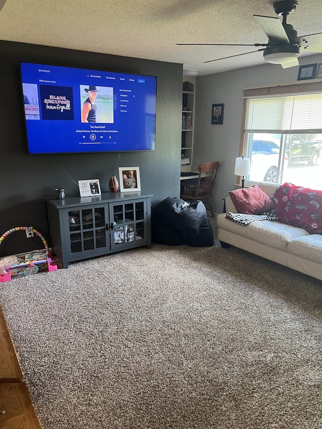 living room featuring ceiling fan and a textured ceiling