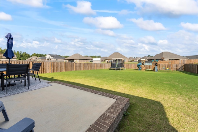 view of yard with a playground, a patio area, and a trampoline