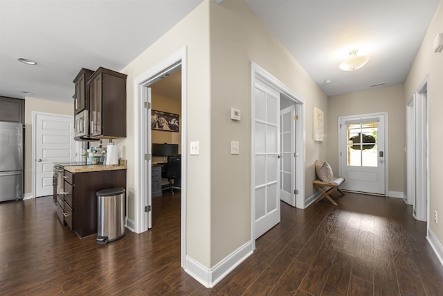 corridor with dark hardwood / wood-style flooring