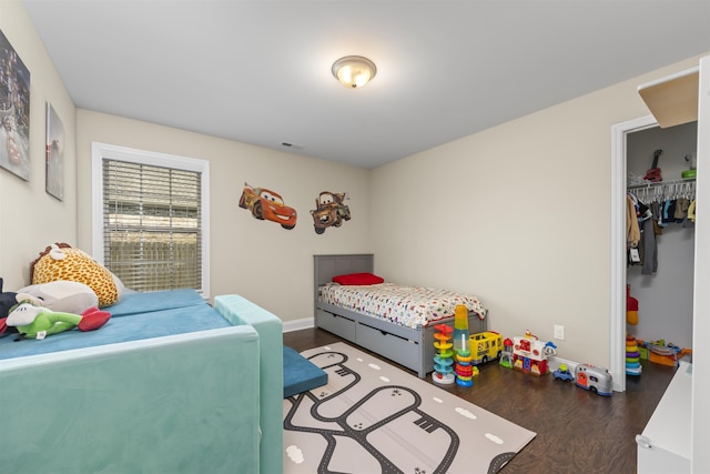 bedroom with dark hardwood / wood-style flooring and a closet