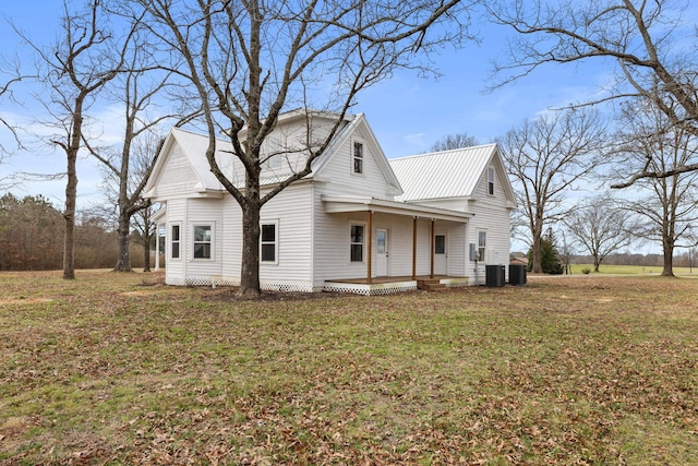 view of front of property with central AC, a porch, and a front lawn