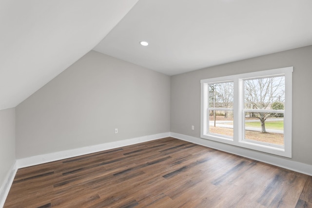 bonus room with dark hardwood / wood-style flooring and lofted ceiling