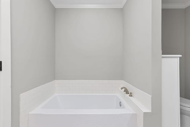 bathroom with a bathtub, ornamental molding, and toilet