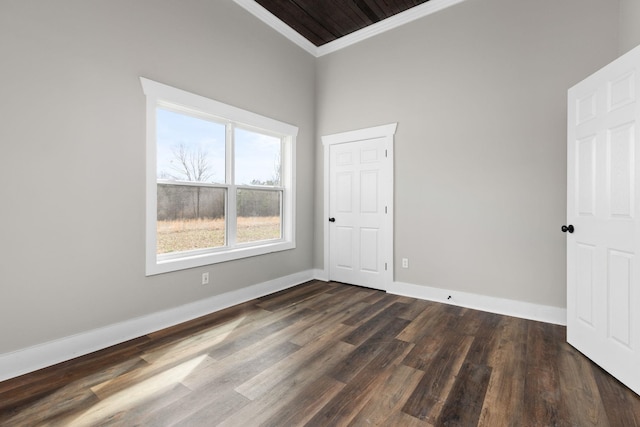 empty room featuring crown molding and dark hardwood / wood-style flooring