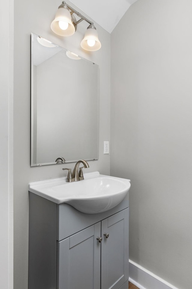 bathroom with vanity and lofted ceiling