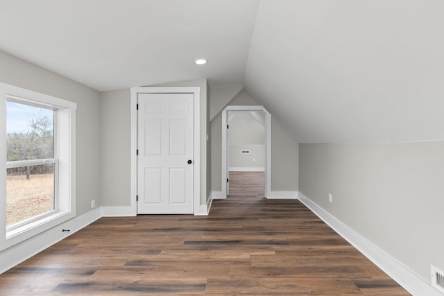 bonus room with dark hardwood / wood-style flooring and lofted ceiling