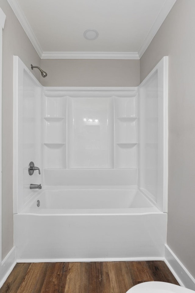 bathroom with hardwood / wood-style flooring, ornamental molding, and  shower combination