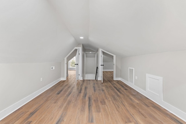 bonus room featuring lofted ceiling and wood-type flooring