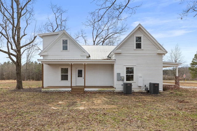 rear view of house featuring central air condition unit