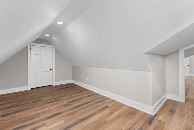 bonus room featuring dark wood-type flooring and lofted ceiling