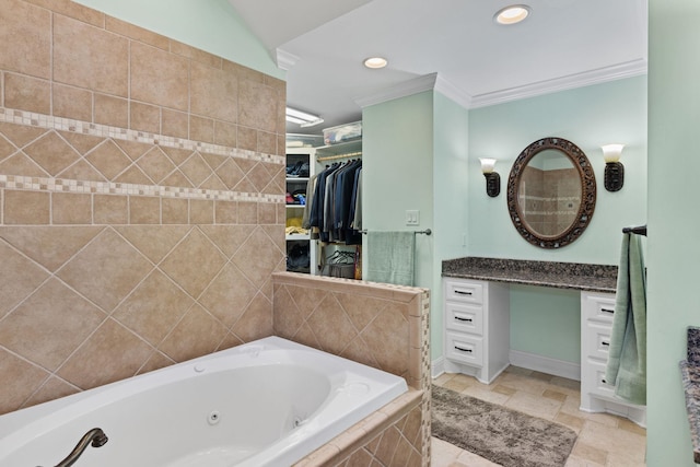 bathroom with tiled tub, crown molding, and vanity