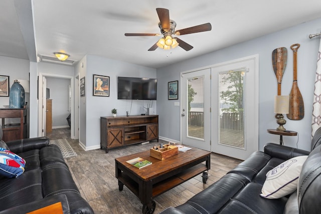 living room featuring a ceiling fan, wood finished floors, and baseboards