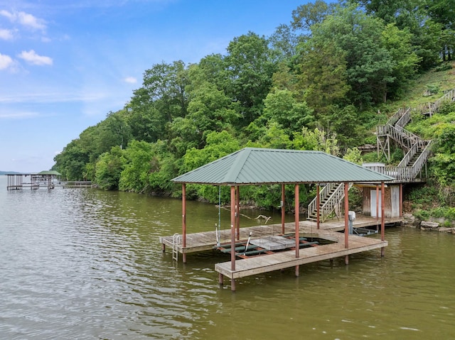 dock area featuring stairway and a water view