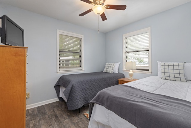 bedroom with wood finished floors, baseboards, and ceiling fan