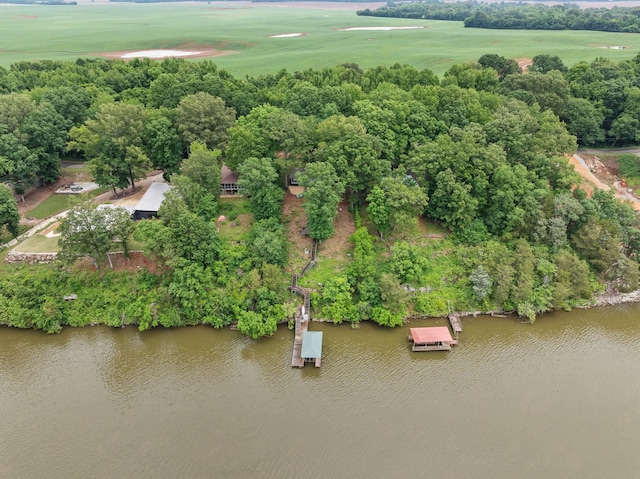 bird's eye view of a nearby body of water, a tree filled landscape, and a local golf course