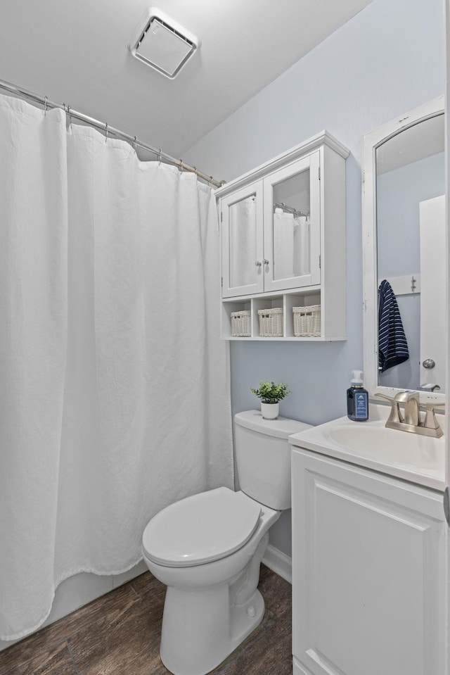 full bathroom featuring toilet, wood finished floors, and vanity