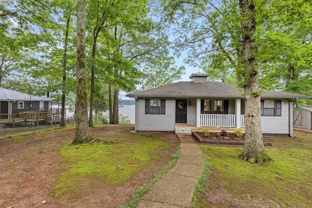 bungalow-style house with covered porch and fence