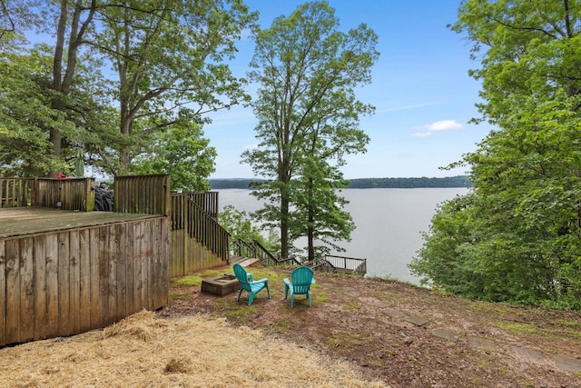 view of yard featuring a water view and a fire pit