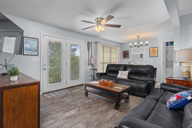 living area featuring a ceiling fan, wood finished floors, and a chandelier