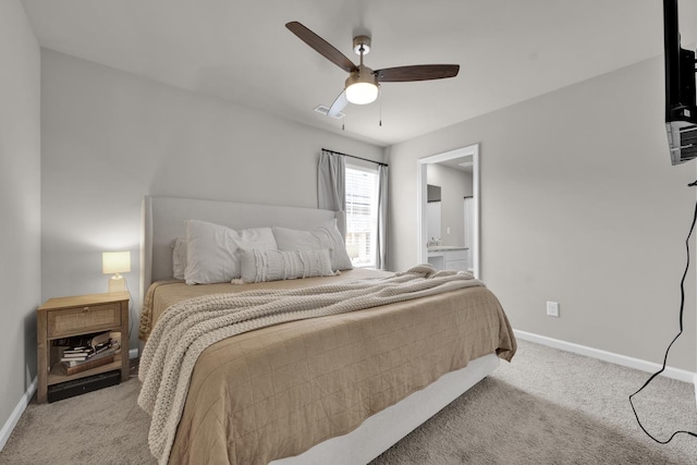  - bedroom featuring light colored carpet, baseboards, ensuite bath, and a ceiling fan