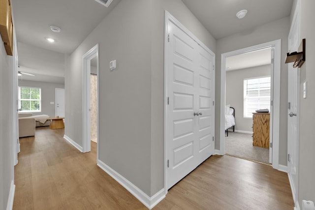  - hallway featuring light wood-type flooring and baseboards